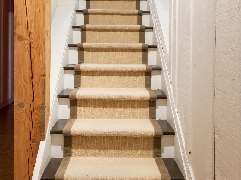 If your treads and risers are still in excellent condition, you could opt for a runner section of carpet down the middle. A great way to renovate a staircase.